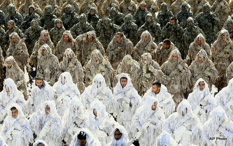 Wearing ghilli suits, members of the Iran's army march during an annual military parade marking the 34th anniversary of outset of the 1980-88 Iran-Iraq war, in front of the mausoleum of the late revolutionary founder Ayatollah Khomeini just outside Tehran, Iran, Monday, Sept. 22, 2014.