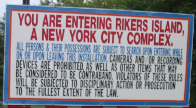 A sign warning visitors that they are entering Rikers Island jail in New York City, photographed on July 25, 2004. Terms of a recent brutality lawsuit settlement will force reforms to the notoriously corrupt correctional facility, but do they go far enough? (Flickr / satanslaundromat)