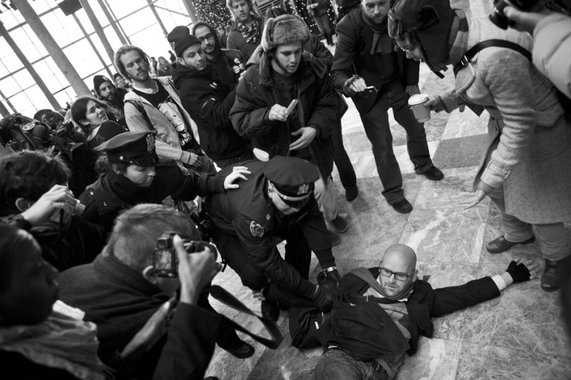 Spectators and citizen journalists film an arrest of an activist by NYPD on their smartphones and digital cameras on December 11, 2011. Social media presents new ways to reach people immediately when news happens, but also can present new challenges when networks act as gatekeepers. (Flickr / Jessica Lehrman)