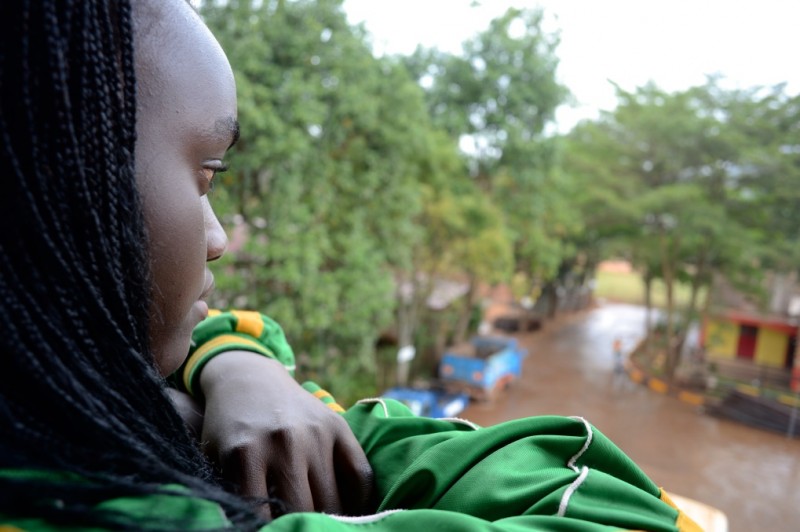 Marlin, a refugee in the Come True project, watches a rainstorm in Uganda. (Rami Gudovitch)