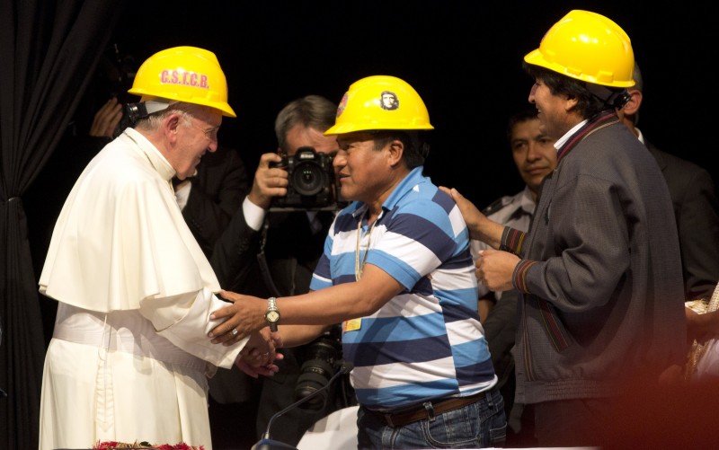 Pope Francis shakes hands with a mining worker's leader, as Bolivia's President Evo Morales, right, stands by, during the second World Meeting of Popular Movements in Santa Cruz, Bolivia, Thursday, July 9, 2015. (AP Photo/Rodrigo Abd)
