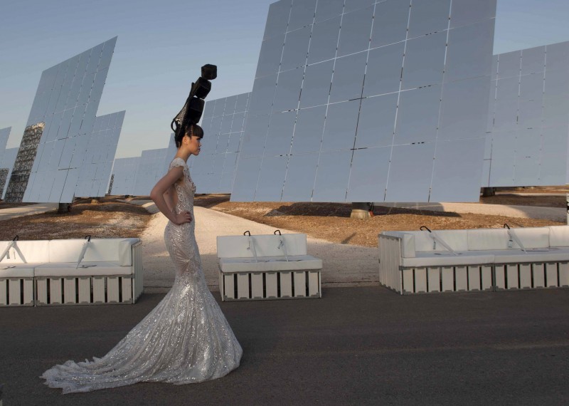 Jessica Minh Anh displays a Vietnamese dress by designer Hoang Hai, during the J Summer Fashion show at the Gemasolar solar plant outside Seville, Spain, Friday July 17, 2015. Billed as the World's first ever solar powered catwalk, model and entrepreneur Jessica Minh Anh, chose the Gemasolar solar plant for her latest unconventional display after organising catwalks on the Eiffel Tower, One World Trade Center, Londons Tower Bridge, and the PETRONAS Twin Towers Skybridge. (AP Photo/Laura Leon)