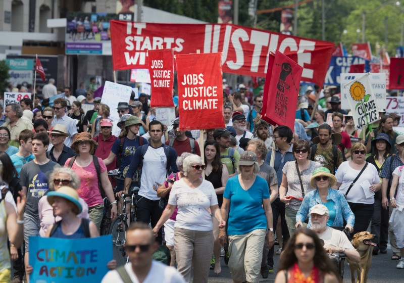 Activists walk down University Avenue during a rally before the Climate Summit of the Americas and the Pan American Economic Summit, Sunday, July 5, 2015, in Toronto. (Darren Calabrese/The Canadian Press via AP) 