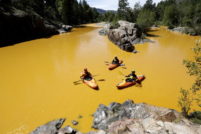 Aug. 6, 2015 People kayak in the Animas River near Durango, Colo., in water colored from a mine waste spill. The Environmental Protection Agency said that a cleanup team was working with heavy equipment Wednesday to secure an entrance to the Gold King Mine, but workers instead released an estimated 1 million gallons of mine waste into Cement Creek, which flows into the Animas River. (Jerry McBride/The Durango Herald via AP)