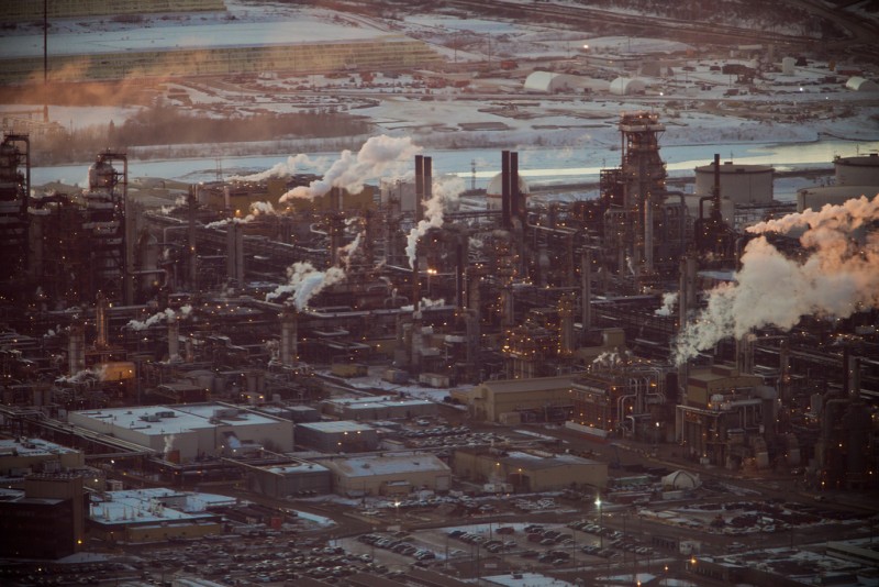 File: Smoke pours from smokestacks in Alberta, Canada on a cold February day. (Flickr / Kris Krüg)
