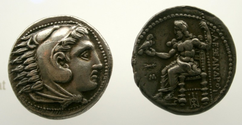 File: Ancient coins from the Ottawa Currency Museum depicting a warrior and a ruler on a throne. (Flickr / Jason Rowe)