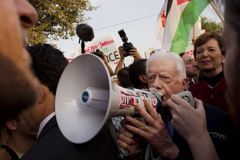 In this Friday, Oct. 22, 2010 file photo, former president of Ireland, Mary Robinson, background right, looks at former U.S. president, Jimmy Carter, center, while visiting a weekly protest in the east Jerusalem neighborhood of Sheikh Jarrah. The protest was organized by groups supporting Palestinians evicted from their homes in east Jerusalem by Israeli authorities. (AP Photo/Bernat Armangue)