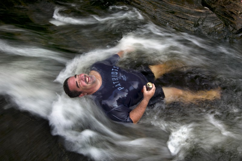 Troy Munford soaks in the waters of Sunday River in Riley Township, Maine, Wednesday, Aug. 19, 2015. Munford, a tour and travel sales manager at the Sunday River Ski Resort, and many of his co-workers were enjoying an afternoon escape from work to beat the heat at the river. "The whole office played hooky," he said. (AP Photo/Robert F. Bukaty)