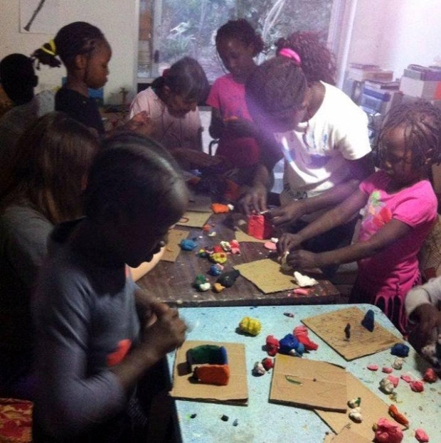 A group of refugee children work together with clay during the creation of "The Dream Of The Magical Sofa," a stop motion film they created with David and Ana Camusso Wapner. (ProMosaik)