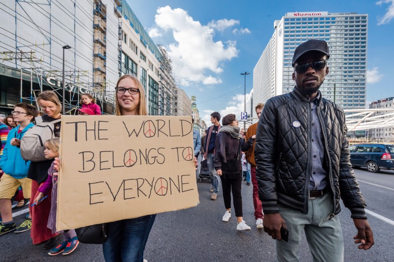 People walk during a solidarity march for refugees in Brussels on Sunday, Sept. 27, 2015. About 15,000 people marched to ask for respect, dignity and humane shelter for refugees in Belgium and Europe. (AP Photo/Geert Vanden Wijngaert)