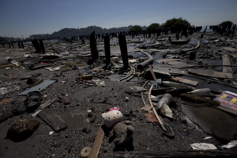 In this Aug. 31, 2015 photo, a Hello Kitty doll lays amid the garbage scattered in Guanabara Bay in Rio de Janeiro, Brazil. Rio Governor Luiz Fernando Pezao recently pushed back the 2016 deadline for cleaning the bay where the Olympic sailing competitions are to be staged, to 2035. (AP Photo/Silvia Izquierdo)