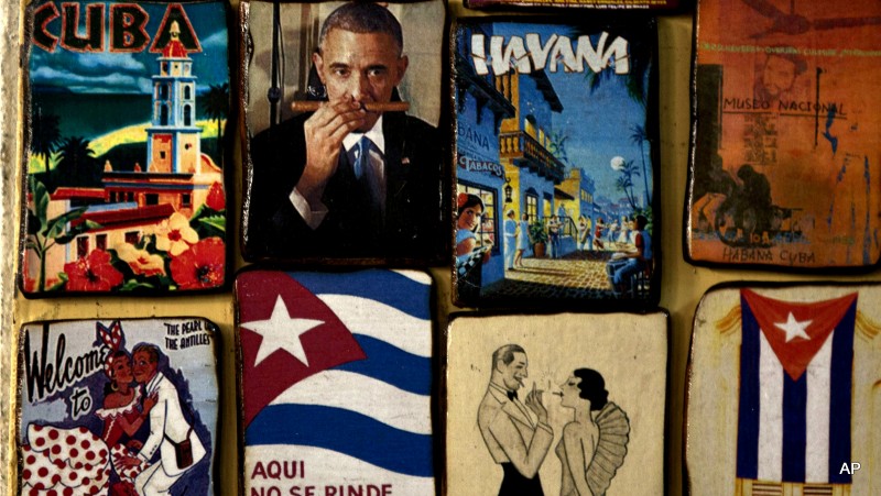 Magnets for sale decorate a tourist shop, one showing an image of U.S. President Barack Obama smelling a cigar, at a market in Havana, Cuba, Monday, March 16, 2015. U.S. and Cuban officials are meeting Monday in last-minute closed door negotiations in Havana, in hopes of restoring full diplomatic relations before the Summit of the Americas in April. The magnet in the bottom row, second from left, reads in Spanish: "Here, nobody gives up," a popular quote attributed to Cuba's late revolutionary hero Camilo Cienfuegos. 