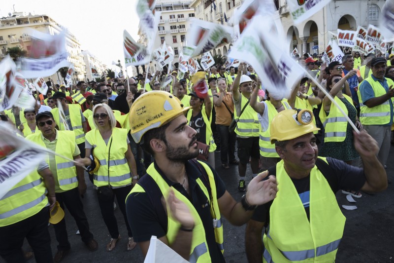 Miners working at a privately-owned gold mine take part in a rally opposing the suspension of all mining and development work in northern Greece, after the leftist government revoked approval of technical studies for the project last month, in the northern Greek port city of Thessaloniki, Saturday, Sept. 5, 2015. (AP Photo/Giannis Papanikos)