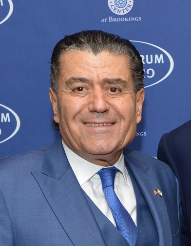 File: Haim Saban in a suit jacket and tie on December 7, 2013. (Wikimedia Commons / U.S. Department of State)