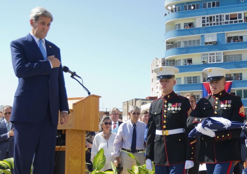 Secretary of State John Kerry watches as U.S. Marines, stationed in Cuba carry the American flag during the raising of the U.S. flag over the newly reopened embassy in Havana, Cuba. Friday, Aug. 14, 2015. Kerry traveled to the Cuban capital to raise the U.S. flag and formally reopen the long-closed U.S. Embassy. Cuba and U.S. officially restored diplomatic relations July 20, as part of efforts to normalize ties between the former Cold War foes. (AP Photo/Pablo Martinez Monsivais,Pool)