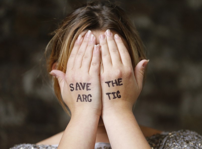 British singer Charlotte Church covers her face with her hands as she joins a Greenpeace protest against drilling for oil in the Arctic, outside the Shell Centre, London, Wednesday, Aug. 26, 2015. (AP Photo/Frank Augstein)