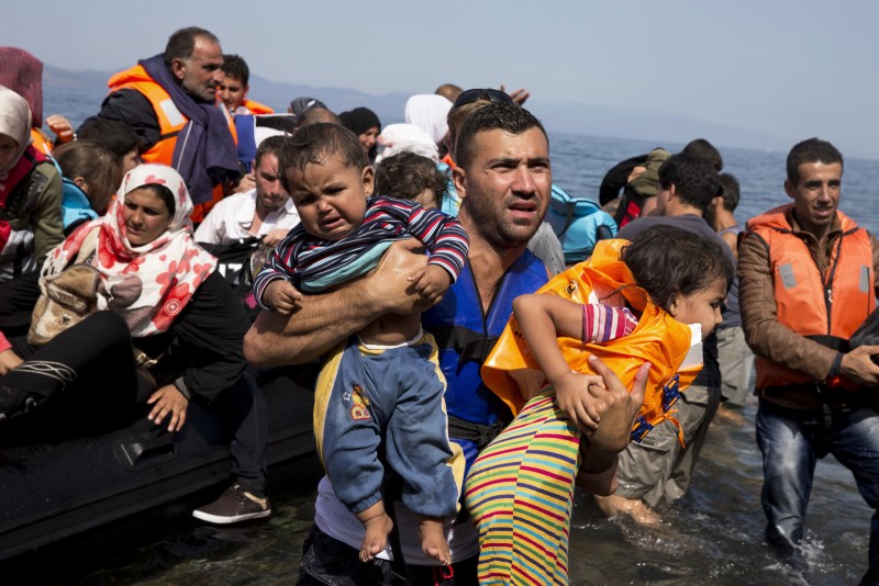 Syrian refugees arrive aboard a dinghy after crossing from Turkey to the island of Lesbos, Greece, Thursday, Sept. 10, 2015. The US is making plans to accept 10,000 Syrian refugees in the coming budget year, a significant increase from the 1,500 migrants that have been cleared to resettle in the U.S. since civil war broke out in the Middle Eastern country more than four years ago, the White House said Thursday. (AP Photo/Petros Giannakouris)
