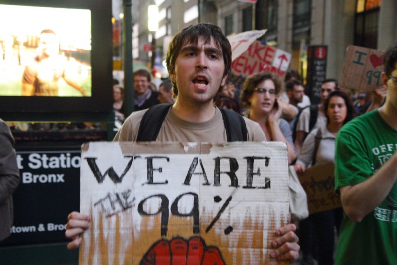 During an Occupy Wall Street march on September 26, 2011, an activist holds a sign which reads "We Are the 99%." (Flickr / Paul Stein)