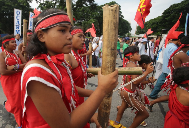 Filipino members of the minority Dumagat tribe join Catholic groups during a march to raise awareness on the dangers of climate change in suburban Quezon city, north of Manila, Philippines as they observe the feast day of St. Francis of Assisi, the patron saint of animals and ecology on Sunday, Oct. 4, 2015. The rallyists said the march was their response to Pope Francis' call for Catholics worldwide to take care of the environment and humanity's common home, mother earth. (AP Photo/Aaron Favila)