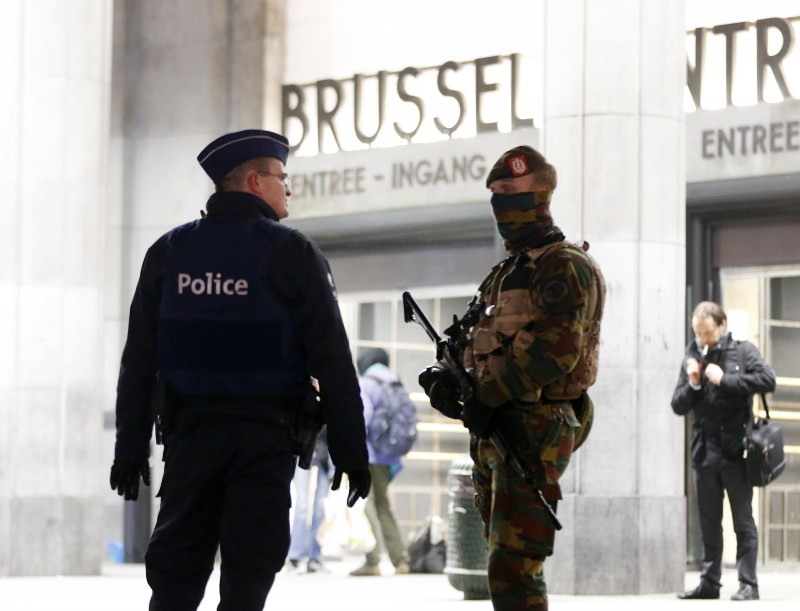 Belgium police officers talk to each other in front of the central station in downtown Brussels, Belgium, Monday, Nov. 23, 2015. The Belgian capital Brussels has entered its third day of lockdown, with schools and underground transport shut and more than 1,000 security personnel deployed across the country. (AP Photo/Michael Probst)