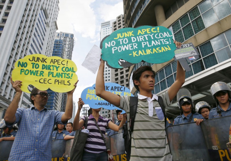 Environmental activists display placards as they picket the venue of the ongoing APEC (Asia Pacific Economic Cooperation) symposium on Climate Change Wednesday, Nov. 4, 2015 at suburban Mandaluyong city east of Manila, Philippines. The protesters are denouncing the alleged promotion of "polluting technology" such as coal-fired power plants by the industrialized nations of APEC-member economies. The APEC Summit of leaders by 21-member nations will be held in Manila Nov.18-19 2015. (AP Photo/Bullit Marquez)