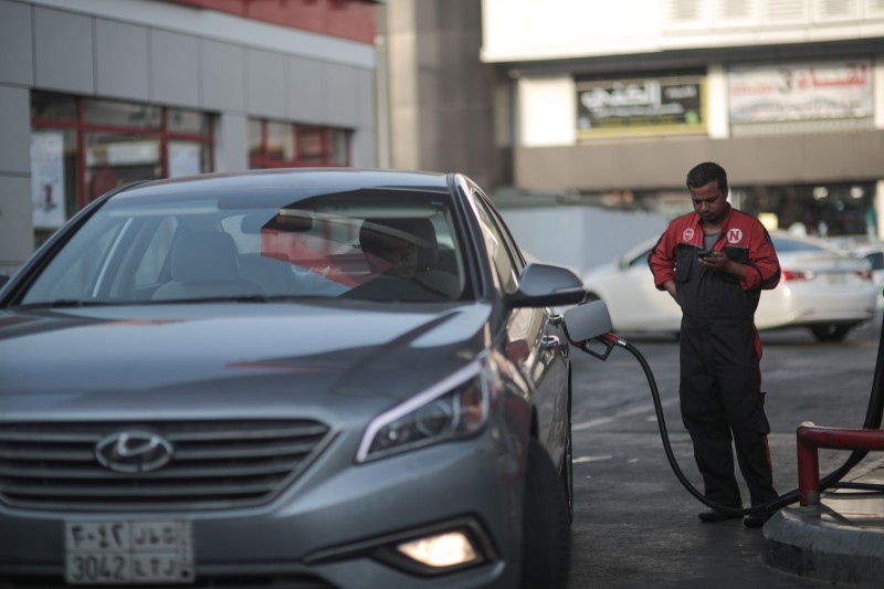 In this Wednesday, Sept. 16, 2015 file photo, a car fills up at a gas station in Jiddah, Saudi Arabia. The kingdom has announced on Monday, Dec. 28, 2015 a projected budget deficit in 2016 of $87 billion (327 billion riyals), as lower oil prices cut into the government's main source of revenue. (AP Photo/Mosa'ab Elshamy, File)
