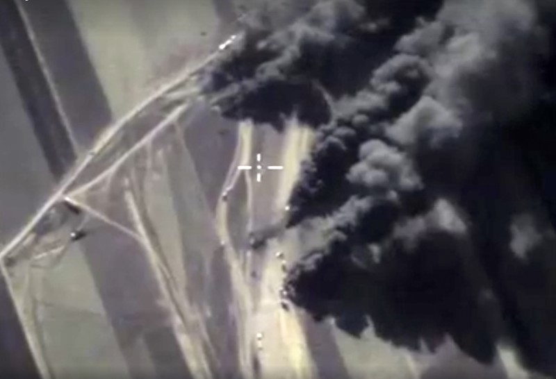 In this photo made from the footage taken from Russian Defense Ministry official web site on Friday, Dec. 25, 2015. showing a target hit during a Russian air raid to eliminate a concentration of oil transporting vehicles in Syria. Russian Defense Ministry said that in the course of the last week, 37 oil production and refinery facilities of terrorists as well as 17 columns of oil trucks have been eliminated. In total, since the beginning of the operation held by the Russian Aerospace Forces, approximately 2,000 such oil trucks have been destroyed in Syria. (Russian Defense Ministry Press Service photo via AP)