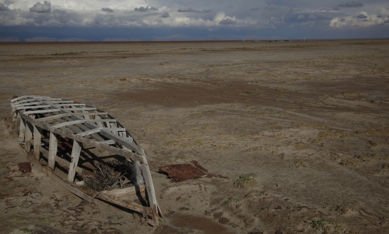 In this Jan. 12, 2016 photo, an abandoned boat lies on the dried up lake bed of Lake Poopo, on the outskirts of Untavi, Bolivia. Environmentalists and local activists say the government mismanaged the lake's fragile water resources and ignored rampant pollution from mining, Bolivias second export earner after natural gas. (AP Photo/Juan Karita)