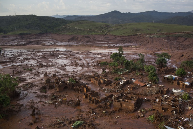 This Nov. 6, 2015, file photo, shows an aerial view of the debris after a dam burst at the small town of Bento Rodrigues in Minas Gerais state, Brazil. Brazils TV Globo said Sunday, Jan. 17, 2106, that the mining company responsible for Latin Americas biggest environmental tragedy on record knew since 2013 that its dam in southeast Brazil had problems. (AP Photo/Felipe Dana, File)