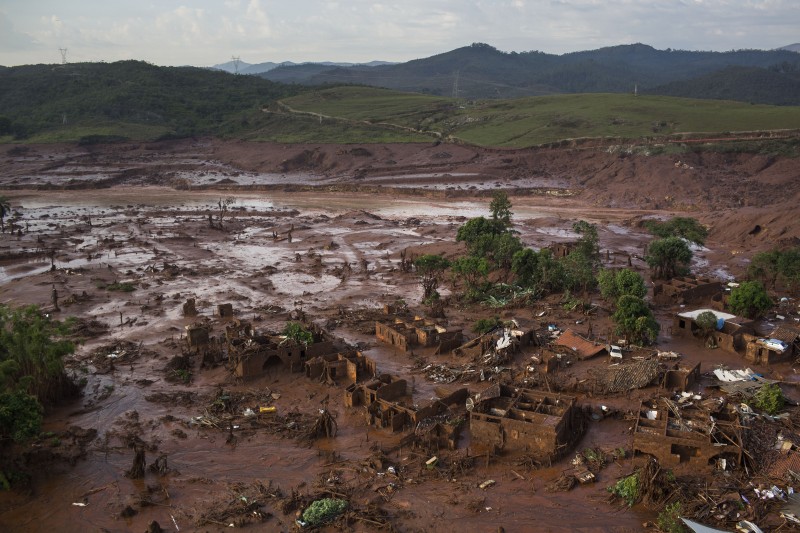 This Nov. 6, 2015, file photo, shows an aerial view of the debris after a dam burst at the small town of Bento Rodrigues in Minas Gerais state, Brazil. Brazils TV Globo said Sunday, Jan. 17, 2106, that the mining company responsible for Latin Americas biggest environmental tragedy on record knew since 2013 that its dam in southeast Brazil had problems. (AP Photo/Felipe Dana, File)