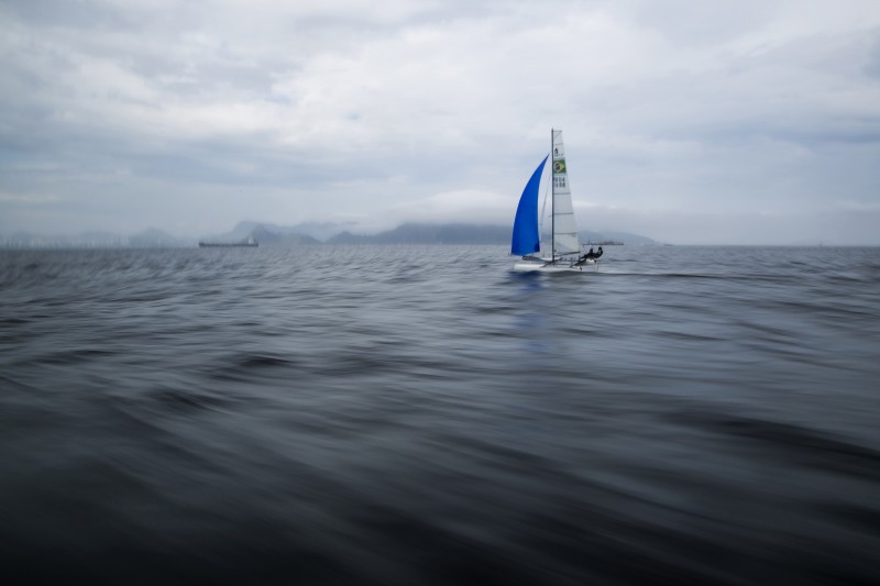 In this Nov. 3, 2015 file photo, Brazilian athletes Samuel Albrecht and Isabel Swan practice in Guanabara Bay in Rio de Janeiro, Brazil. Independent testing of Guanabara Bay conducted by AP over the last year shows disease-causing viruses linked to human sewage at levels thousands of times above what would be considered alarming in the U.S. or Europe. The tests include the venue for sailing, but also Rio's Olympic venues for rowing, canoeing, open-water swimming and triathlon. (AP Photo/Felipe Dana, File)