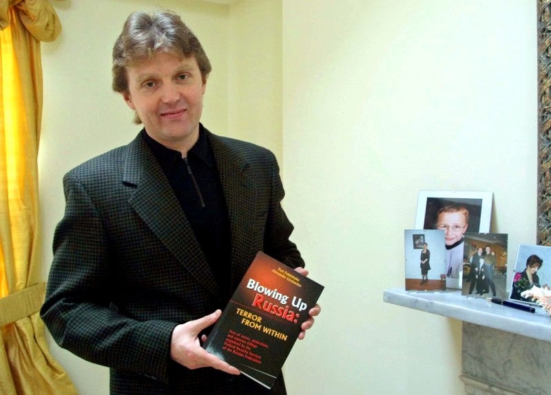 A Friday, May 10, 2002 file photo showing Alexander Litvinenko, former KGB spy and author of the book "Blowing Up Russia: Terror From Within" photographed at his home in London. A coroner overseeing a British inquest into the 2006 poisoning death of Alexander Litvinenko has requested a public inquiry to be held so that crucial evidence can be scrutinized. Coroner Robert Owens request to Justice Secretary Christopher Grayling Wednesday, June 5, 2013, followed a ruling last month stating that sensitive evidence _ including documents relating to Russias alleged role in the agents death _ has to be excluded from the existing inquest. The ruling was made after British Foreign Secretary William Hague applied to the inquest to keep some evidence surrounding the case secret on national security grounds. Litvinenko, a 43-year-old former agent turned Kremlin critic, died in November 2006, after drinking tea laced with the radioactive isotope polonium-210 at a London hotel. (AP Photo/Alistair Fuller, File)