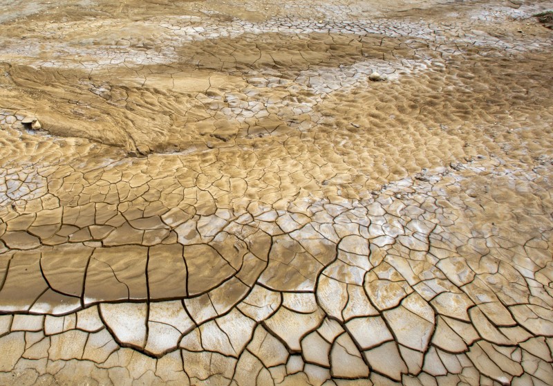 This Feb. 20, 2016 photo shows the dry, cracked lakebed of Trou Caiman, in Croix-des-Bouquets, Haiti. A drought worsened by the El Nino weather phenomenon has driven Haitians who were already barely getting by on marginal farmland deeper into misery. An estimated 1.5 million people are going hungry as crop yields fall to lowest levels in 35 years in a country where two-thirds of people eke out a living from agriculture. (AP Photo/Dieu Nalio Chery)