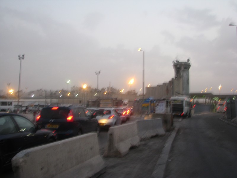 A row of cars lines up to pass through Qalandia checkpoint in Palestine's West Bank into Israel-controlled territory. (Peter Crowley)