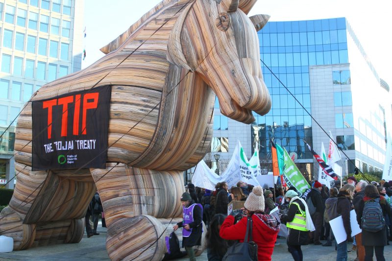 A massive inflatable Trojan Horse at a TTIP protest on February 4, 2015, with a banner reading "TTIP: The Trojan Treaty." (Flickr / greensefa)
