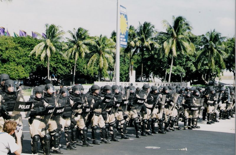 A row of armored riot police prepare to attack activists at a protest against the Free Trade Area of the Americans negotiations in Miami, Florida. (Flickr / Shooting Chris)
