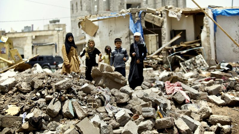 A boy and his sisters watch graffiti artists spray on a wall, commemorating the victims who were killed in Saudi-led coalition airstrikes in Sanaa, Yemen, Monday, May 18, 2015. Saudi-led airstrikes targeting Yemen's Shiite rebels resumed early on Monday in the southern port city of Aden after a five-day truce expired amid talks on the war-torn country's future that were boycotted by the rebels. (AP Photo/Hani Mohammed)