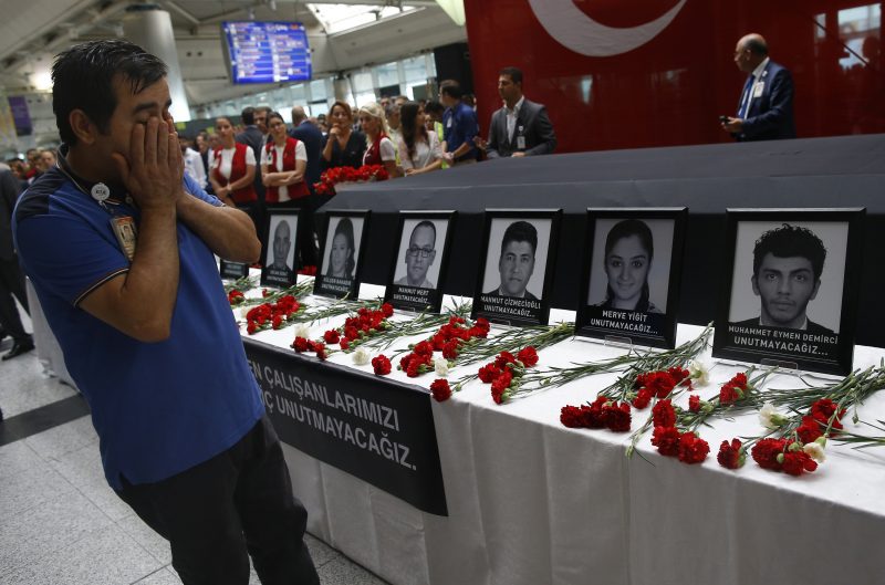 In this Thursday, June 30, 2016 photo, family members, colleagues and friends of the victims of Tuesday blasts gather for a memorial ceremony at the Ataturk Airport in Istanbul. As millions of Muslims around the world celebrate the end of Ramadan, many are struggling to come to grips with what has been a particularly bloody month of attacks that killed more than 350 people and spread terror across continents. (AP Photo/Emrah Gurel, File)