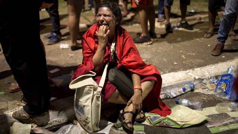 A government supporter cries after the lower house of Congress voted to impeach Brazil's President Dilma Rousseff, outside Congress in Brasilia, Brazil, Sunday, April 17, 2016. The measure now goes to the Senate. Rousseff is accused of using accounting tricks in managing the federal budget to maintain spending and shore up support. (AP Photo/Felipe Dana)