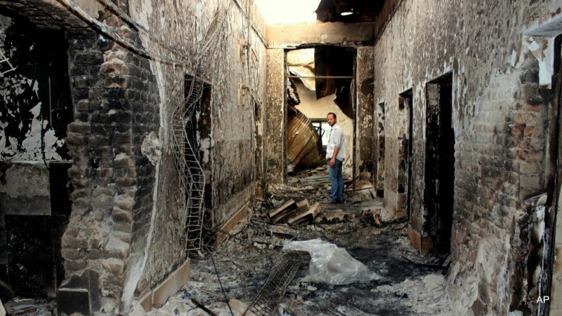 In this Friday, Oct. 16, 2015 photo, an employee of Doctors Without Borders stands inside the charred remains of their hospital after it was hit by a U.S. airstrike in Kunduz, Afghanistan. Christopher Stokes, general director of Doctors Without Borders, which is also known by its French abbreviation MSF, whose hospital in northern Afghanistan was destroyed in a U.S. airstrike, says the “extensive, quite precise destruction” of the bombing raid casts doubt on American military assertions that it was a mistake. (Najim Rahim via AP)