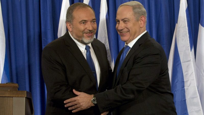 Israeli Prime Minister Benjamin Netanyahu, right, and Foreign Minister Avigdor Lieberman shake hands in front the media after giving a statement in Jerusalem. (AP Photo/Bernat Armangue)