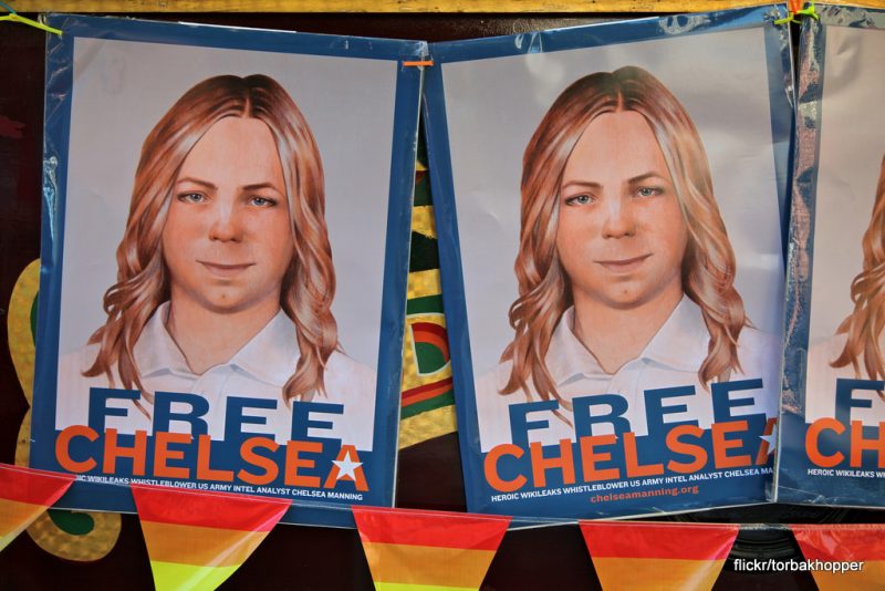 Signs read "Free Chelsea Manning" with an artists' rendition of the whistleblower. 