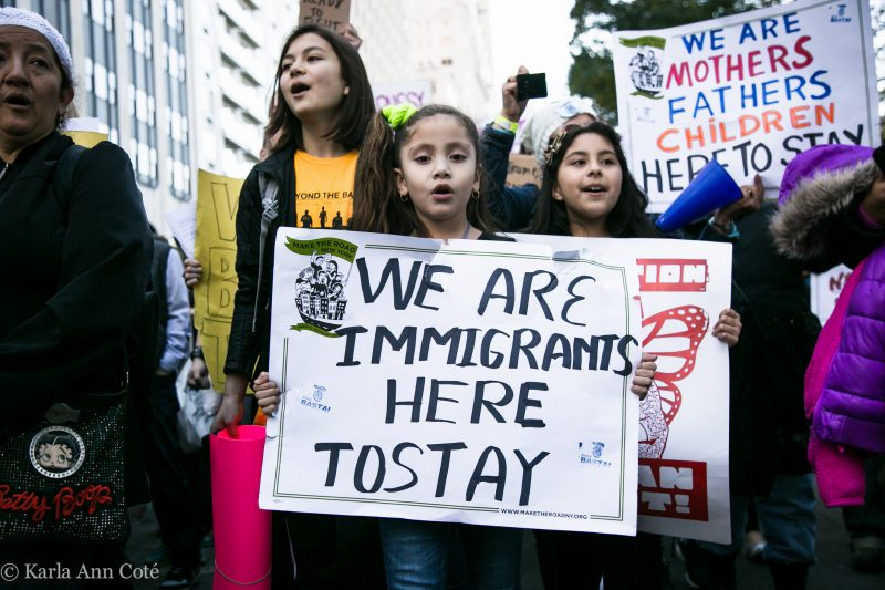 At a November 13, 2016 protest against President-elect Donald Trump in New York City, young activists hold a sign reading, "We are immigrants here to stay." (Flickr / Karla Ann Cote)