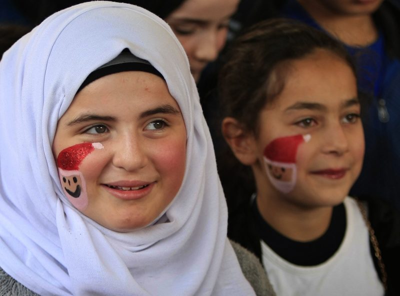 Muslim and Christian children, with their faces painted with Santa Claus, attend a Christmas event inside a church in the southern port city of Sidon, Lebanon, Sunday, Dec. 4, 2016. (AP Photo/Mohammed Zaatari)
