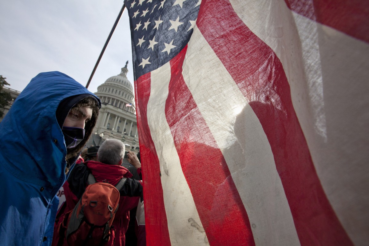 As Congress returns from its winter recess, protesters aligned with the Occupy Wall Street movement demonstrate on Capitol Hill in Washington, Tuesday, Jan. 17, 2012. (AP Photo/J. Scott Applewhite)