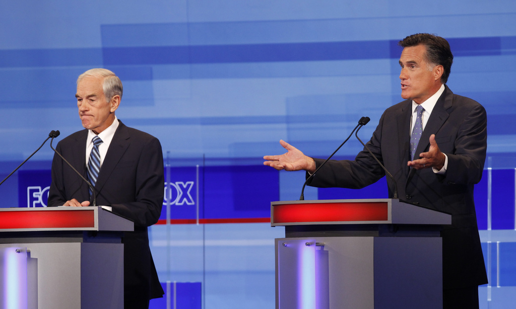 Republican presidential candidates former Massachusetts Gov. Mitt Romney and Rep. Ron Paul, R-Texas are pictured during the Iowa GOP/Fox News Debate at the CY Stephens Auditorium in Ames, Iowa, Thursday, Aug. 11, 2011. (AP Photo/Charlie Neibergall, Pool)
