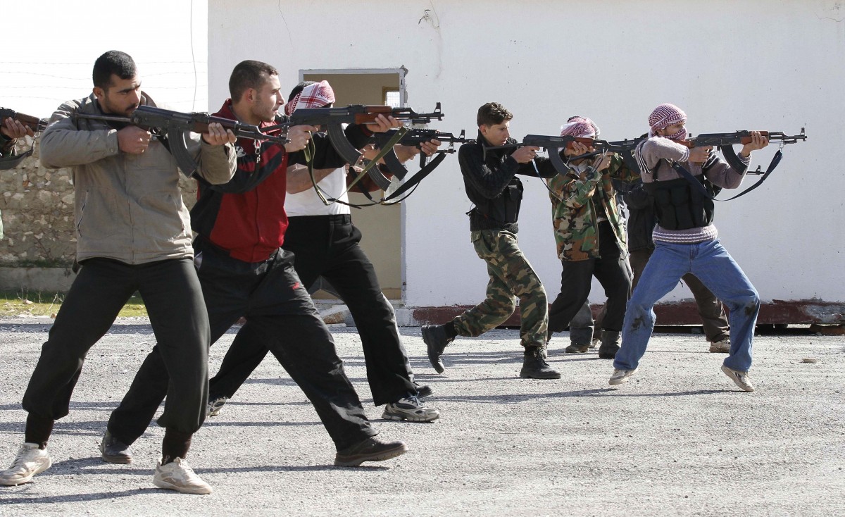Syrian rebels aim during a weapons training exercise outside Idlib, Syria, Tuesday, Feb. 14, 2012. Syrian government forces renewed their assault on the rebellious city of Homs on Tuesday in what activists described as the heaviest shelling in days, as the U.N. human rights chief raised fears of civil war. (AP Photo)