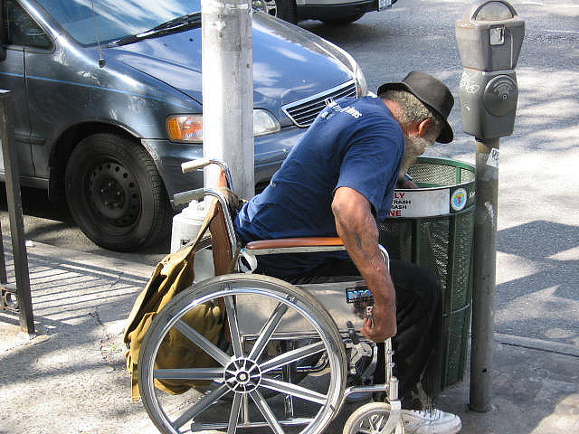 A man searches through a garbage container in New York. (Photo by Carlos Martinez)