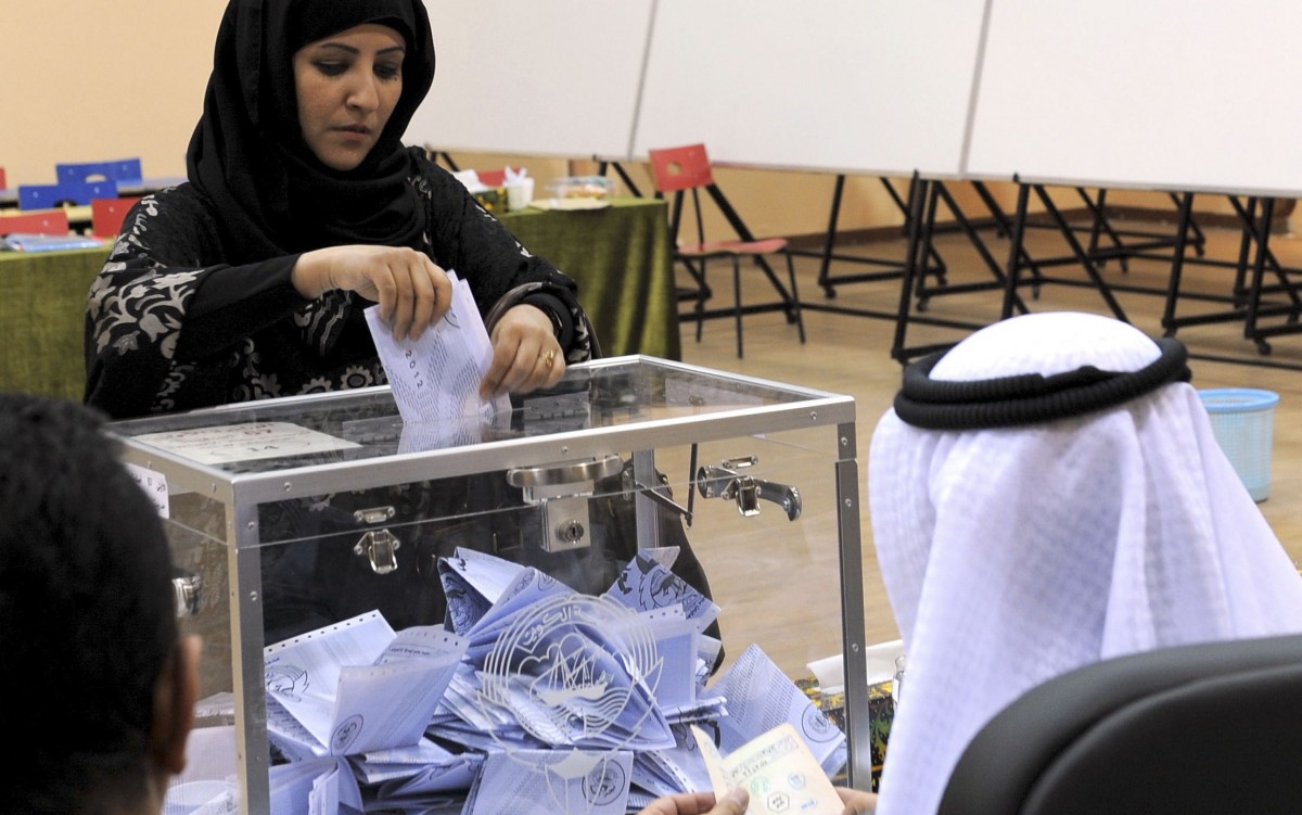 A Kuwaiti woman casts her vote at a polling station in Salwa, Kuwait City on Thursday, Feb. 2, 2012. Officials said 400,296 Kuwaitis are registered to vote in the first parliamentary election since May 2009. The more than 280 candidates include 23 women, including re-election bids by four lawmakers who were the first women in the assembly. (AP Photo/Gustavo Ferrari)