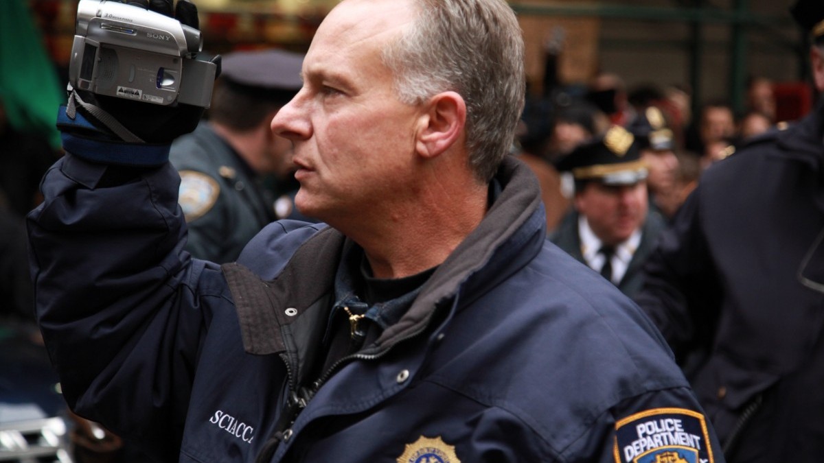 A NYPD officer records Occupy protestors (Photo by Palinopsia Films)